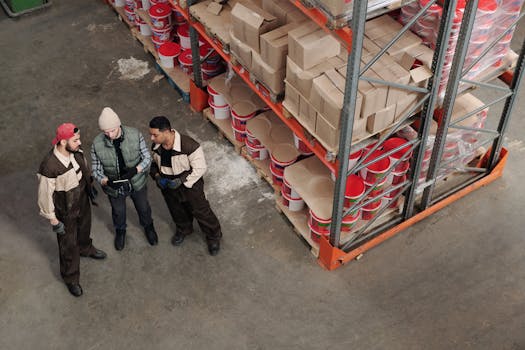 Workers reviewing stock inside a commercial warehouse